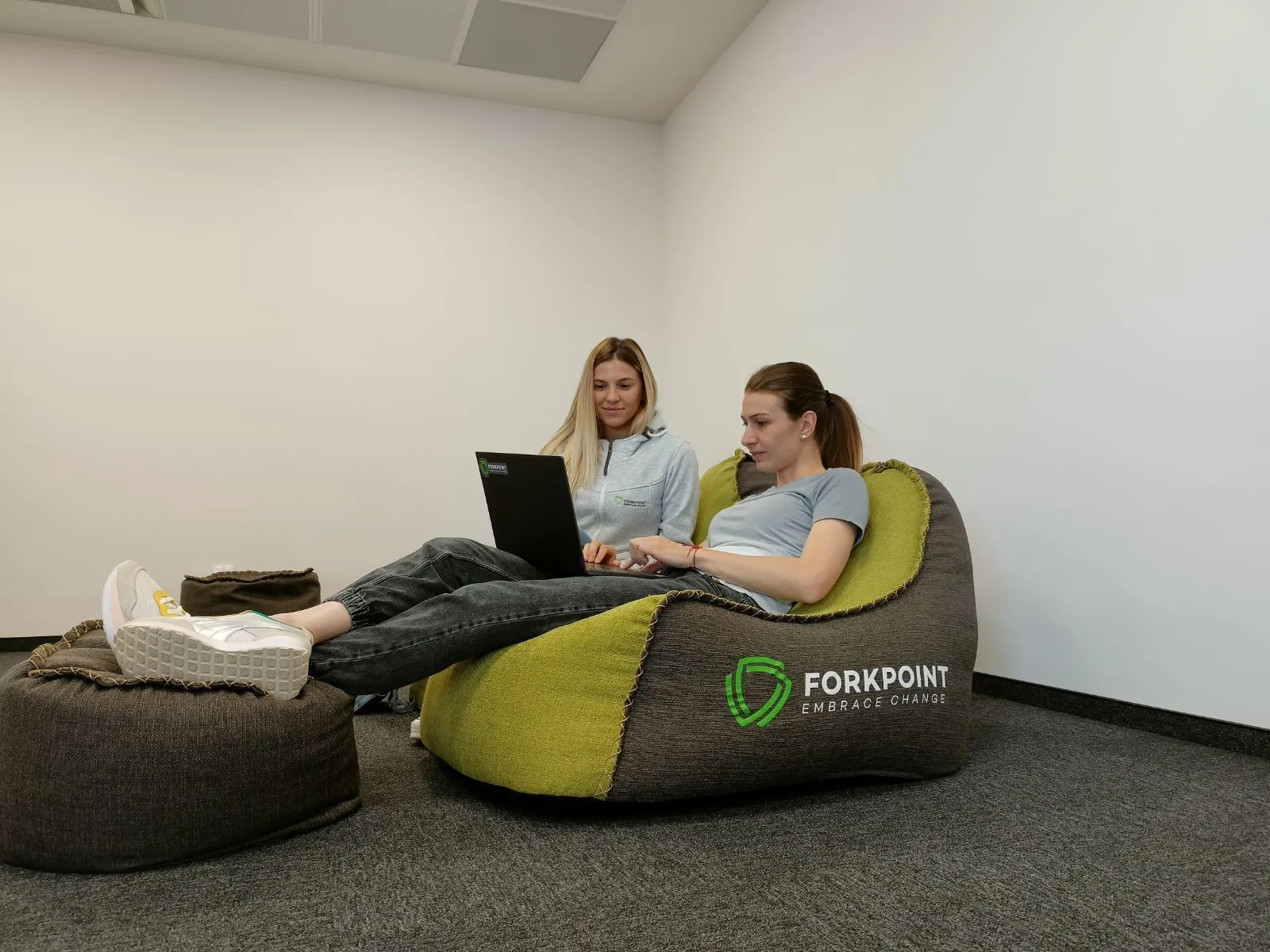 Team working on beanbags with laptops