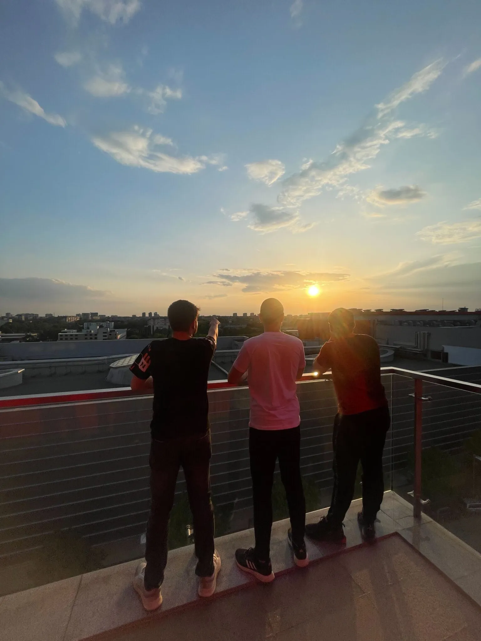 Team gathering at rooftop sunset